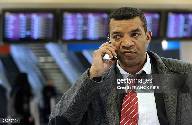 France's national rugby union team assistant coach Emile Ntamack makes a phone call on January 29, 2010 at Orly airport, near Paris, before joining...