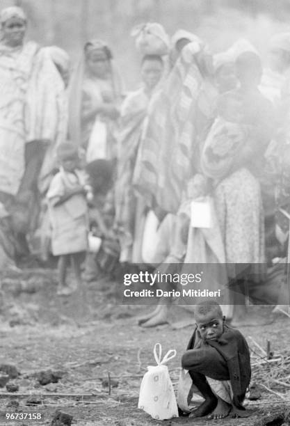 Child orphaned during the 1994 Rwandan genocide is waiting for help in one of the refugee camps set up around the city of Goma, Zaire , on July 1994....