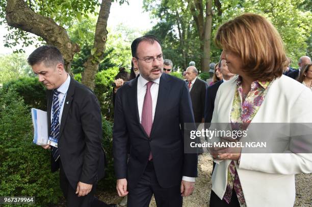 Mexico's Foreign Affairs Secretary Luis Videgaray walks with Colombia's Foreign Minister María Ángela Holguín after posing for the family photo...