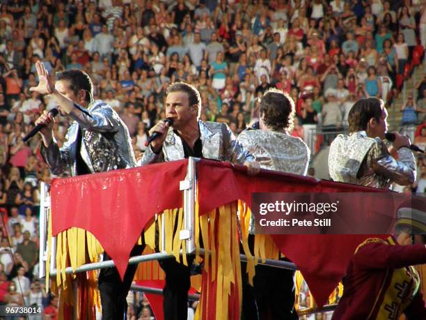 Jason Orange, Gary Barlow, Howard Donald and Mark Owen of Take That perform on board a giant mechanical elephant on the final date of their 'Circus'...