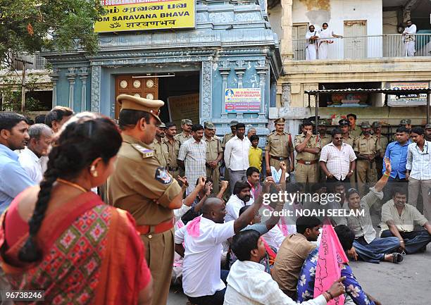 Indian police stand guard at the famous Subramanya Swamy Hindu Temple as members of the Telangana Rashtra Samithi party hold a protest in...