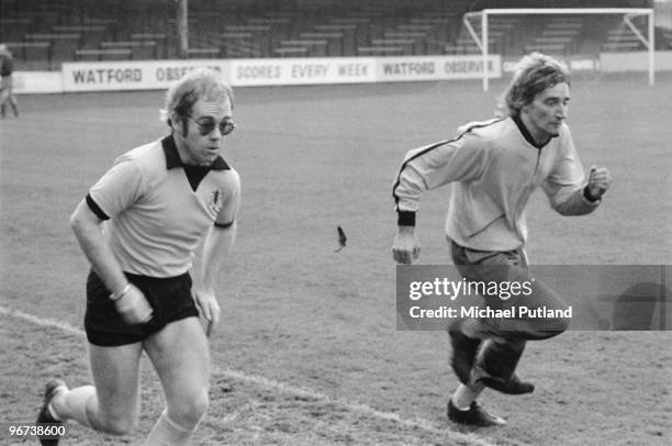 British singers Elton John Rod Stewart training at Watford Football Club, London, November 1973.