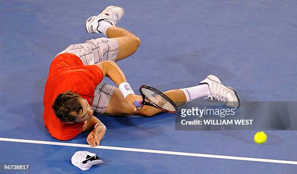 Tennis player Bob Bryan falls on the court during his men's doubles final match with partner Mike Bryan against Daniel Nestor of Canada and Nenad...