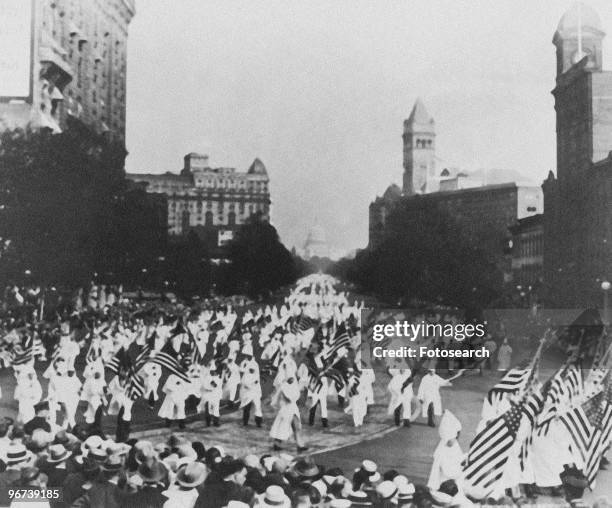 Photograph of Ku Klux Klan parade through Washington DC circa 1926. .