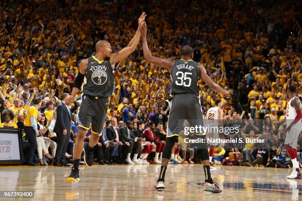 David West and Kevin Durant of the Golden State Warriors exchange a high five during the game against the Cleveland Cavaliers in Game Two of the 2018...