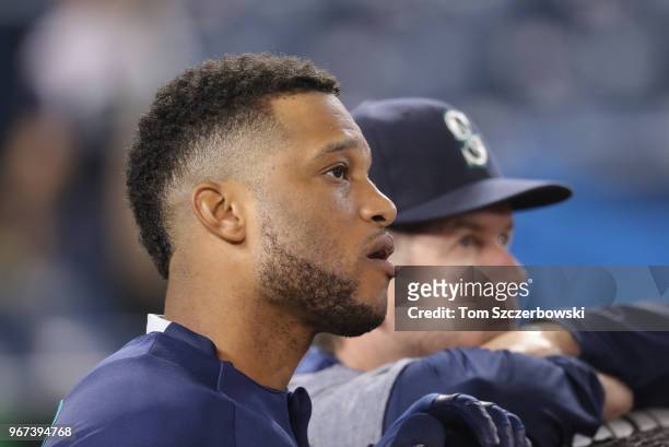 Robinson Cano of the Seattle Mariners and hitting coach Edgar Martinez look on during batting practice before the start of MLB game action against...