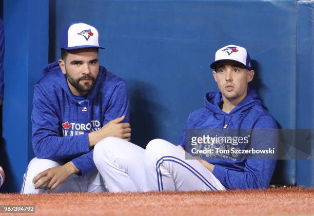 Jaime Garcia of the Toronto Blue Jays and Aaron Sanchez look on as they sit on the top step of the dugout during MLB game action against the Seattle...