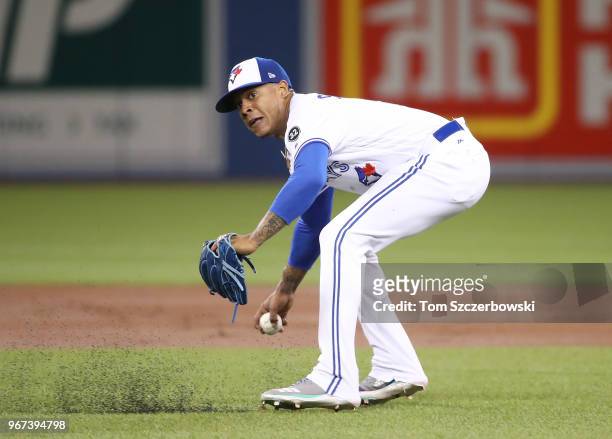 Marcus Stroman of the Toronto Blue Jays recovers after being hit by a line drive up the middle to throw out Jean Segura of the Seattle Mariners in...