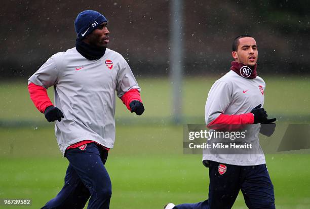 Theo Walcott and Sol Campbell of Arsenal warm up during an Arsenal training session, ahead of Wednesday's Champions League match against FC Porto,...