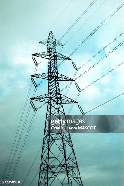 High tension electricity poles, France Pylone electrique sur fond de ciel bleu orageux. Zone de flou sur le haut et le bas due la structure.