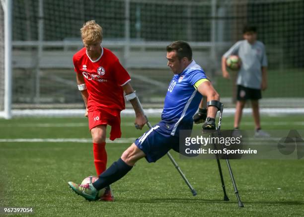 Team England Jamie Tregaskiss and Team USA Nico Calabria fight for ball during the Lone Star Invitational Amputee Soccer tournament on June 2, 2018...