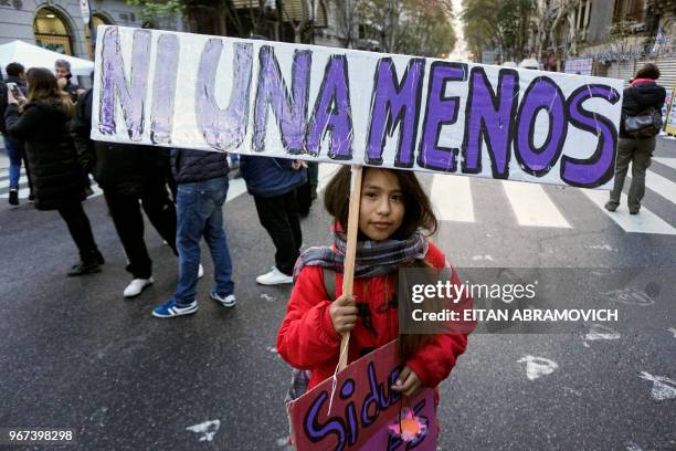 Little girl takes part in a march called by the movement "Ni una menos" against violence against women, and in demand of the right to a safe, free...