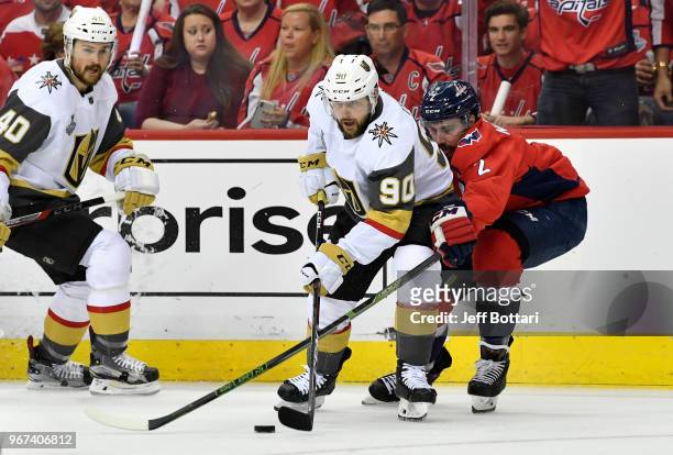 Tomas Tatar of the Vegas Golden Knights battles Matt Niskanen of the Washington Capitals for the puck during the first period of Game Four of the...