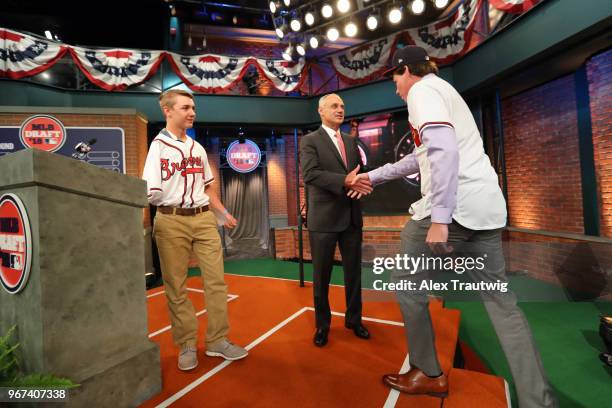 Major League Baseball Commissioner Robert D. Manfred Jr. Shakes hands with eighth overall selection in the 2018 MLB Draft Carter Stewart during the...