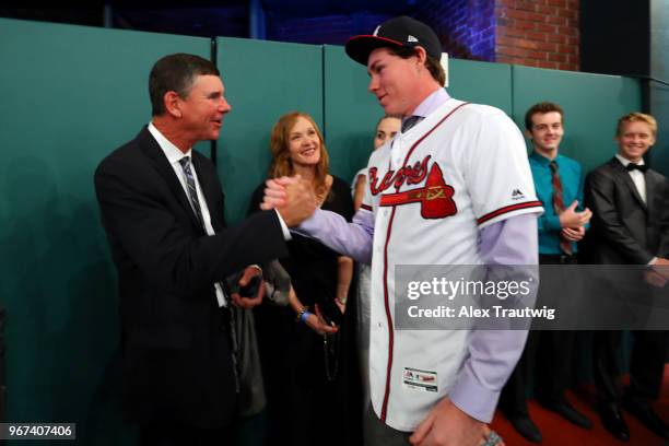 Carter Stewart who selected eighth overall in the 2018 MLB Draft by the Atlanta Braves shakes hands with his dad during the 2018 Major League...