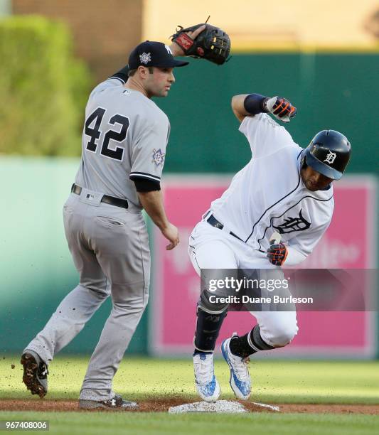 Leonys Martin of the Detroit Tigers makes it safe at second base on a double as second baseman Neil Walker of the New York Yankees covers the bag...