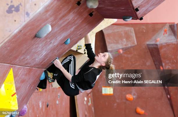 Compétition sportive d'escalade sur blocs en salle.