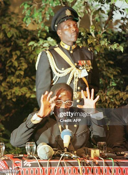 Zimbabwean President Robert Mugabe addresses a press conference while his guard gazes-up, at the end of the 12th Non-Aligned Movement summit in...