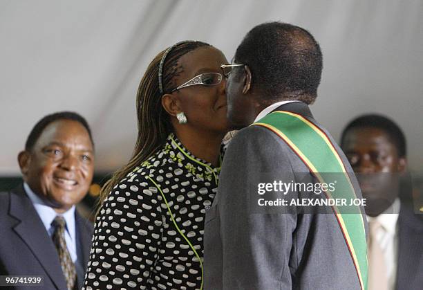 Zimbabwean President Robert Mugabe is being congratulated by his wife Grace Mugabe after being sworn in for a sixth term in office in Harare, on June...