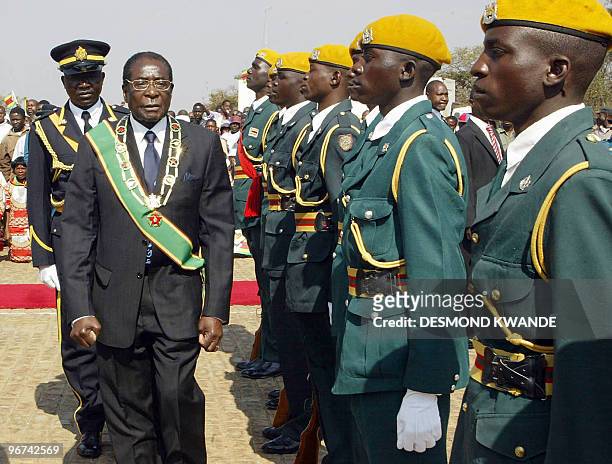 Zimbabwe's President Robert Mugabe inspects an honour guard upon his arrival to attend Heroes' Day commemorations in Harare 13 August 2007. Zimbabwe...