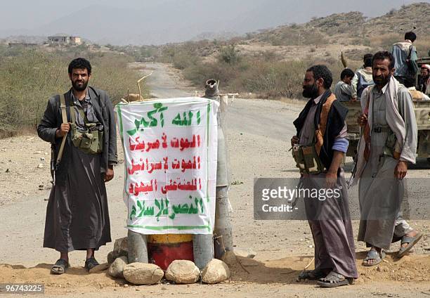 Yemeni Shiite Huthi rebels stand at a checkpoint in Saada, north of Sanaa, on February 16, 2010 as others re-open a road following a truce between...