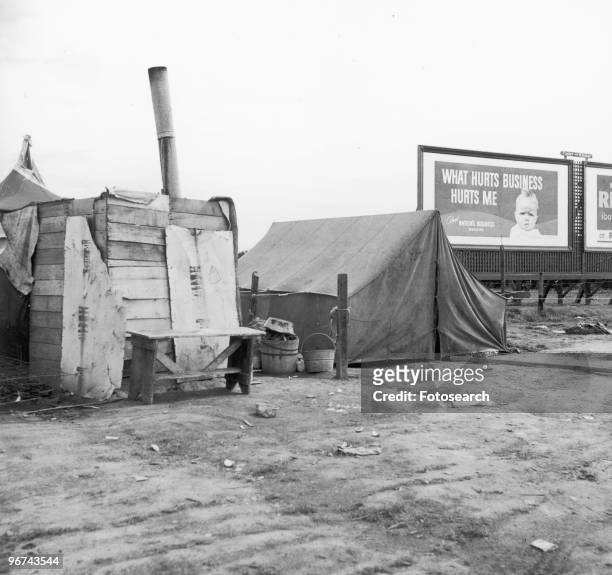 Tent and a shack in a migrant camp - photographed by Dorothea Lange - in California, USA, circa 1938. .