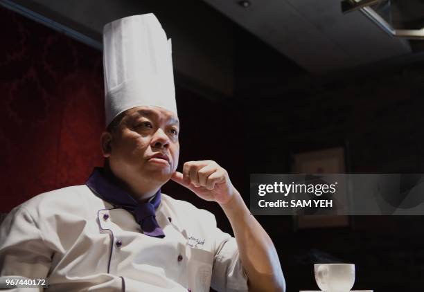 This picture taken on May 17, 2018 shows Ken Chan, the executive chef at the five-star hotel restaurant Le Palais in Taipei, gesturing during an...