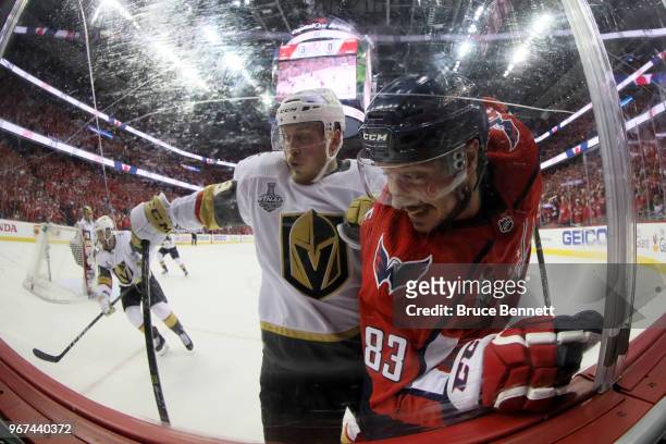 Nate Schmidt of the Vegas Golden Knights and Jay Beagle of the Washington Capitals battle along the boards during the first period in Game Four of...