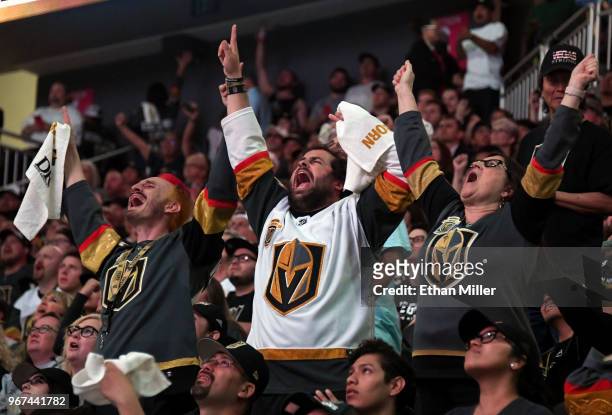 Vegas Golden Knights fans Jay Bryant-Chavez, Brock Williams and Pamela Salas, all of Nevada, react during a Golden Knights road game watch party for...