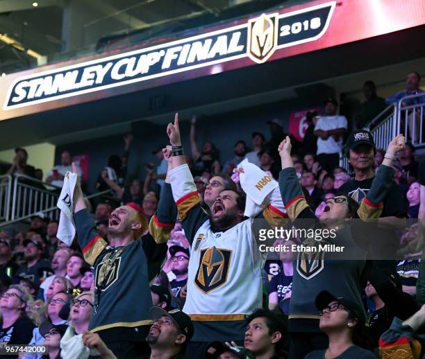 Vegas Golden Knights fans Jay Bryant-Chavez, Brock Williams and Pamela Salas, all of Nevada, react during a Golden Knights road game watch party for...
