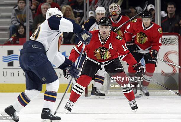 Patrick Sharp of the Chicago Blackhawks waits in position in front of Tobias Enstrom of the Atlanta Thrashers on February 13, 2010 at the United...