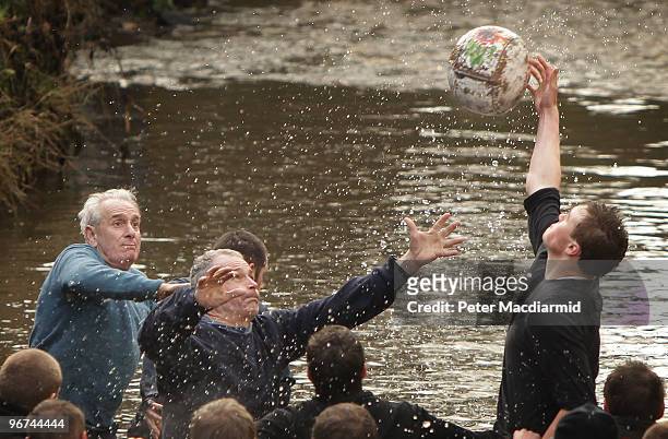 Rival teams, the 'Up'ards and Down'ards', battle for the ball in Henmore Brook during the annual Shrove Tuesday 'no rules' football match on February...