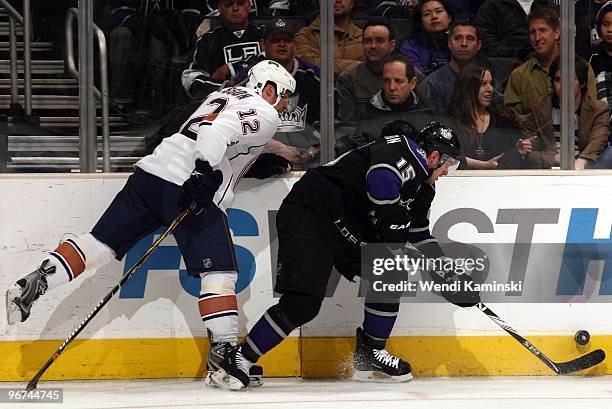 Brad Richardson of the Los Angeles Kings skates with the puck along the boards against Robert Nilsson of the Edmonton Oilers on February 11, 2010 at...