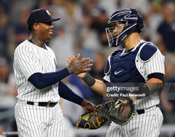 Pitcher Aroldis Chapman of the New York Yankees celebrates with catcher Gary Sanchez after Chapman struck out Martin Maldonado of the Los Angeles...