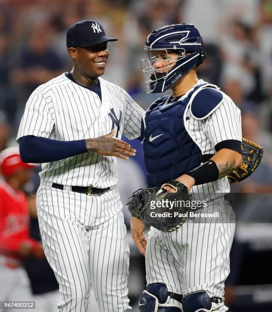 Pitcher Aroldis Chapman of the New York Yankees celebrates with catcher Gary Sanchez after Chapman struck out Martin Maldonado of the Los Angeles...