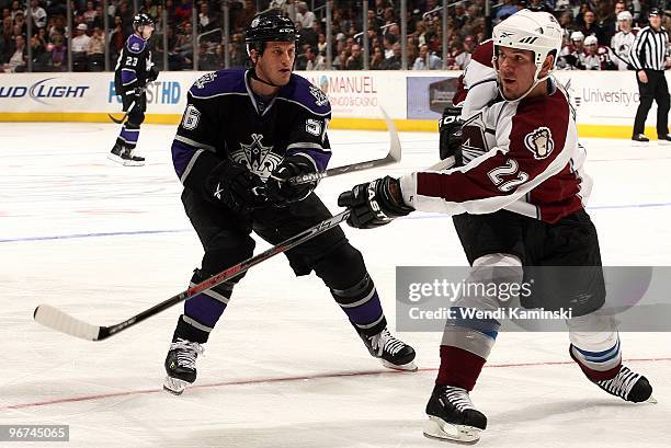 Scott Hannan of the Colorado Avalanche passes against RIch Clune of the Los Angeles Kings on February 13, 2010 at Staples Center in Los Angeles,...