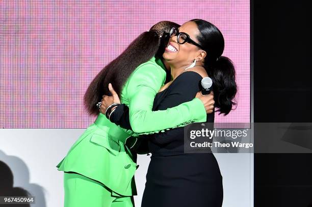 Issa Rae hugs Oprah Winfrey onstage during the 2018 CFDA Fashion Awards at Brooklyn Museum on June 4, 2018 in New York City.