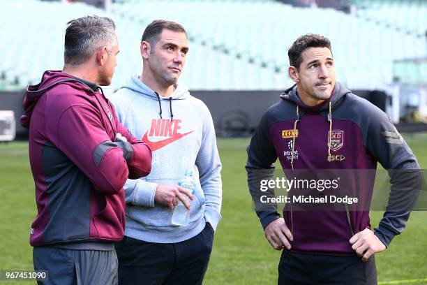 Maroons legend Cameron Smith and Billy Slater, out with a hamstring injury, look on during a Queensland Maroons Captain's Run at the Melbourne...