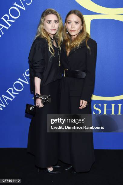 Designers Ashley Olsen and Mary-Kate Olsen pose with 2018 CFDA Accessories Designer of The Year award during the 2018 CFDA Fashion Awards Winners...