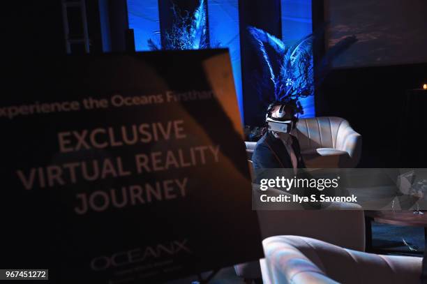 Guest uses a VR headset during the Launch Of OceanX, a bold new initiative for ocean exploration, at the American Museum of Natural History on June...