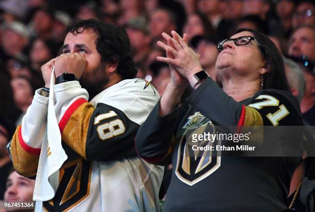 Vegas Golden Knights fans Brock Williams and Pamela Salas, both of Nevada, react during a Golden Knights road game watch party for Game Four of the...