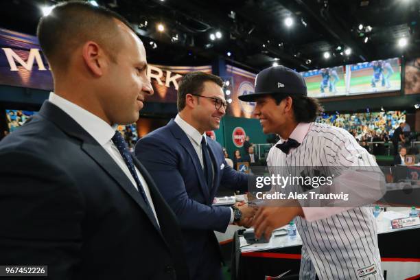 Anthony Seigler who was drafted 23rd overall by the New York Yankees shakes hands with Nick Swisher during the 2018 Major League Baseball Draft at...