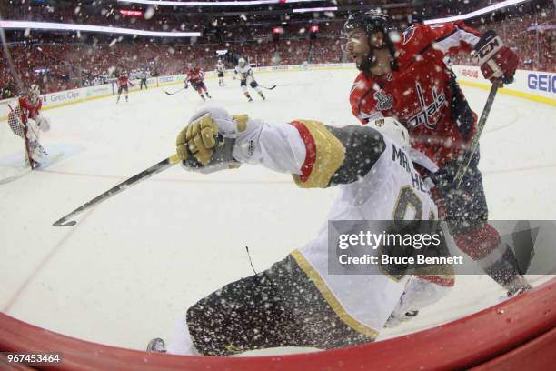 Matt Niskanen of the Washington Capitals and Jonathan Marchessault of the Vegas Golden Knights battle along the boards during the second period in...