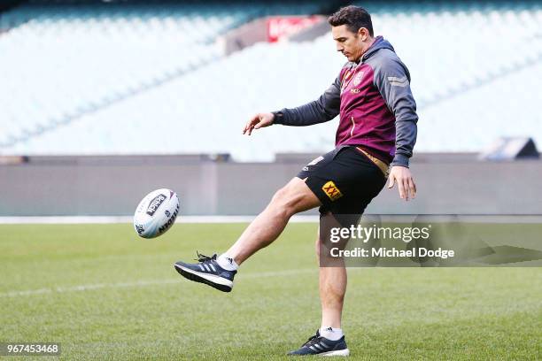 Billy Slater, out with a hamstring injury, kicks the ball with his left leg on the field during a Queensland Maroons Captain's Run at the Melbourne...