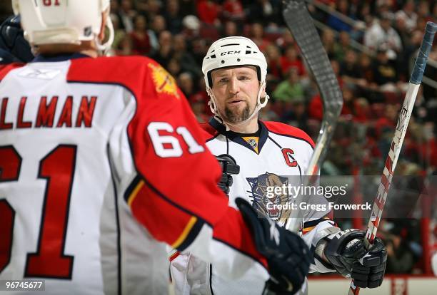 Bryan McCabe of the Florida Panthers skates over to congratulate teammate Cory Stillman after scoring a 2nd period goal during a NHL game against the...