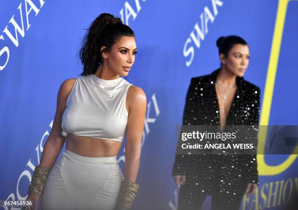 Personality Kim Kardashian West and Kourtney Kardashian arrives at the 2018 CFDA Fashion awards June 4, 2018 at The Brooklyn Museum in New York.