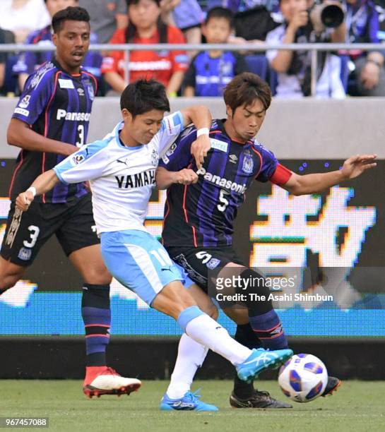 Seiya Nakano of Jubilo Iwata and Genta Miura of Gamba Osaka compete for the ball during the J.League Levain Cup play-off first leg match between...