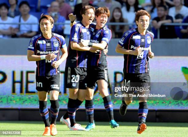 Hwang Ui Jo of Gamba Osaka celebrates scoring the opening goal with his team mates during the J.League Levain Cup play-off first leg match between...
