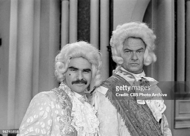 American actors Burt Reynolds and Harvey Korman , both in ruffled shirts and wigs, appear on an episode of the television comedy & variety program...