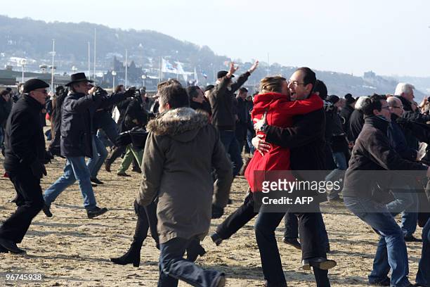 Couples re-enact the kiss scene of French film director Claude Lelouch's 1966 movie, "Une Homme et Une Femme" film filmed on Deauville's beach...